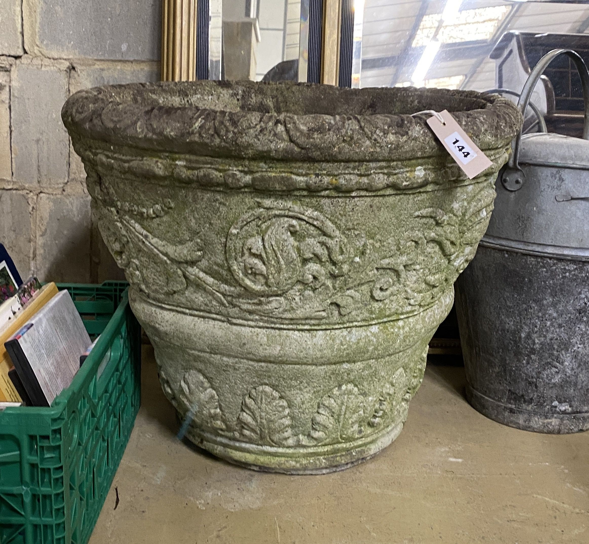 A large circular reconstituted stone garden planter, diameter 54cm, height 44cm